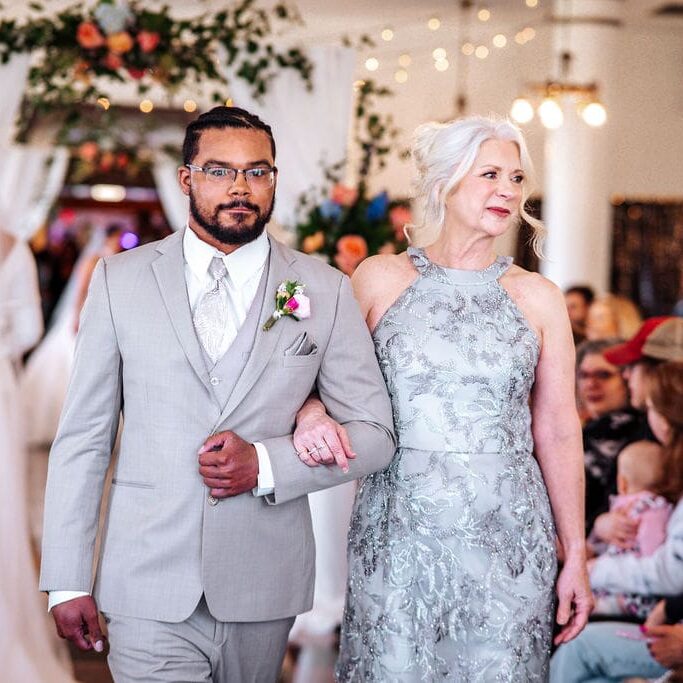 Couple walking together down the wedding aisle.