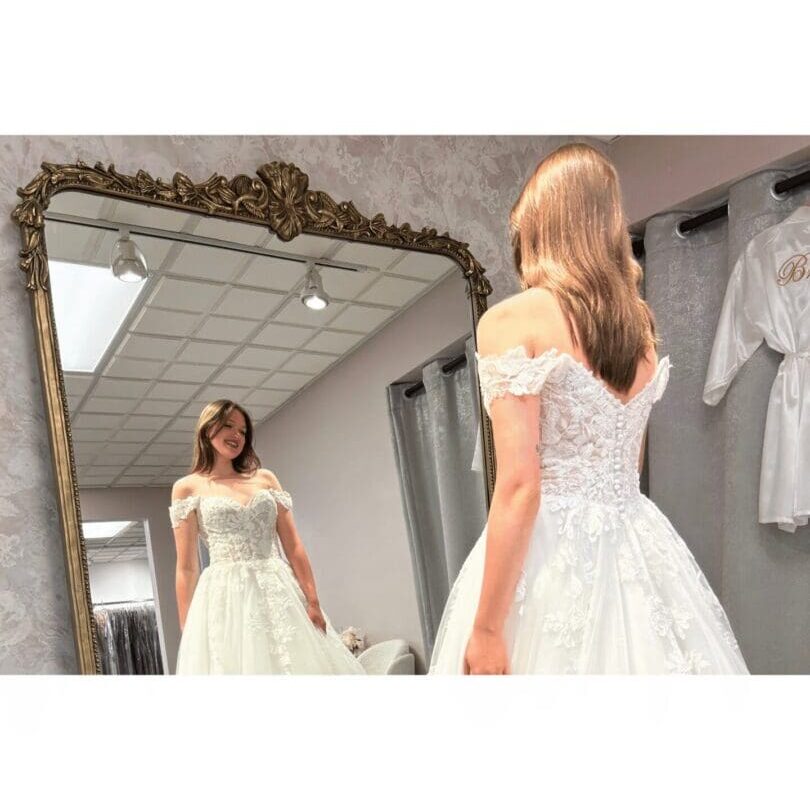 Woman trying on white wedding dress
